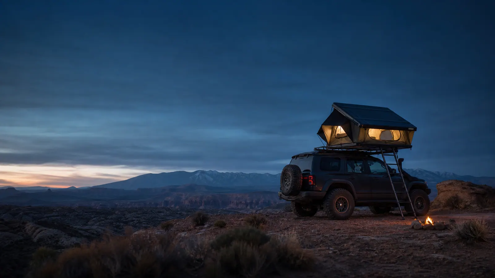 Rooftop tent camp beneath a mountain sky